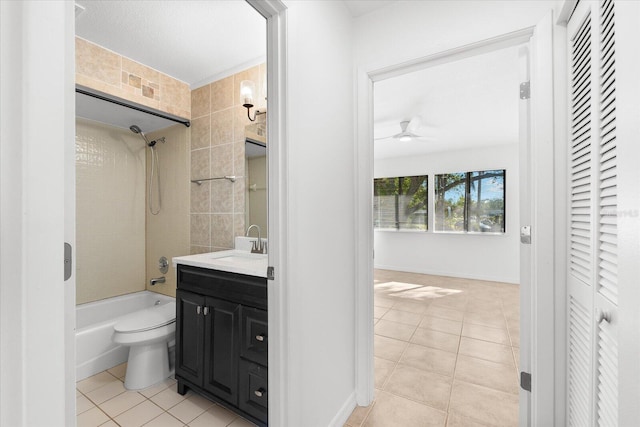 full bathroom featuring toilet, ceiling fan, tiled shower / bath, tile patterned floors, and vanity