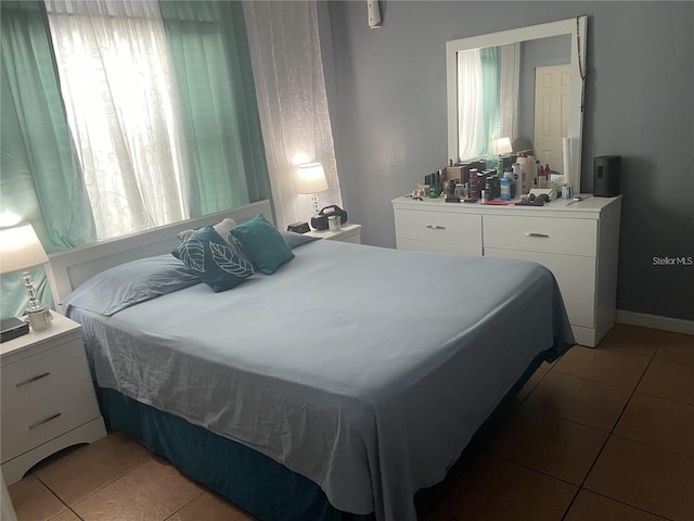 bedroom featuring tile patterned flooring and multiple windows