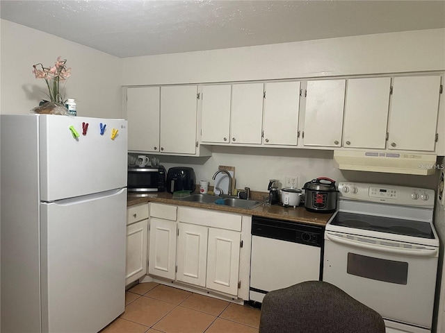 kitchen featuring white cabinetry, sink, light tile patterned flooring, and white appliances