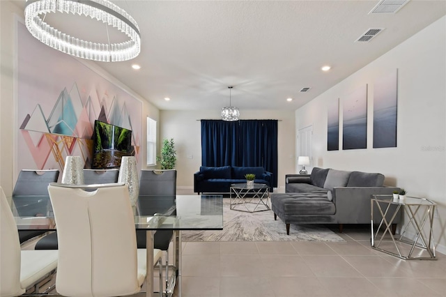 tiled living room featuring an inviting chandelier