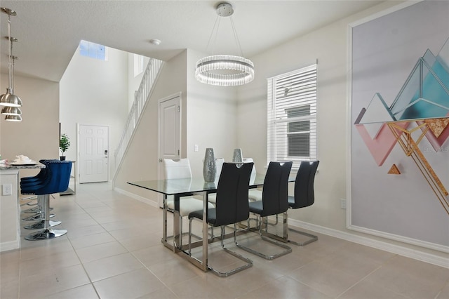 tiled dining area featuring a notable chandelier