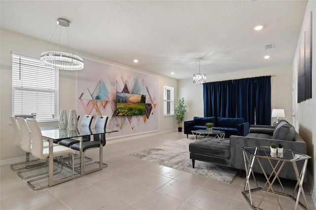 living room with a wealth of natural light and an inviting chandelier