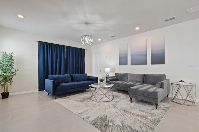 tiled living room featuring an inviting chandelier