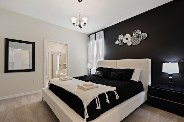 bedroom featuring an inviting chandelier, carpet floors, and ensuite bath