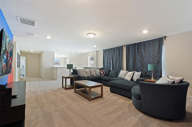 living room featuring light colored carpet and a textured ceiling