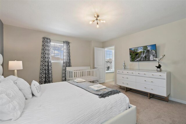 carpeted bedroom featuring multiple windows