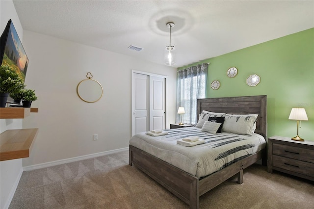 carpeted bedroom with a closet