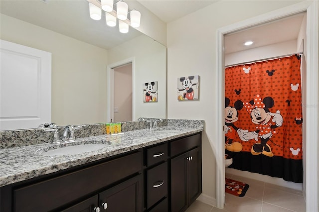 bathroom featuring tile patterned flooring, vanity, a shower with shower curtain, and toilet