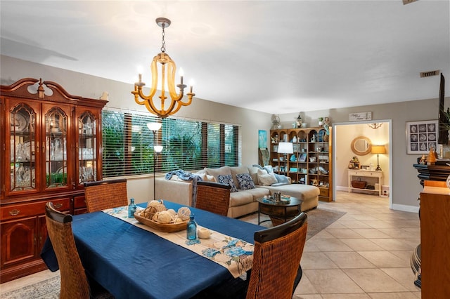 dining area with light tile patterned floors and a chandelier