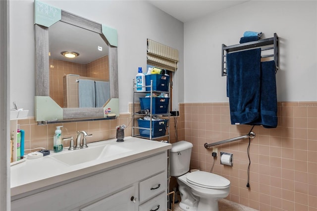 bathroom with vanity, toilet, a shower with door, and tile walls