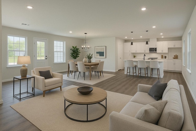 living area with baseboards, recessed lighting, and dark wood finished floors