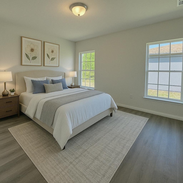 bedroom featuring dark wood-type flooring and baseboards