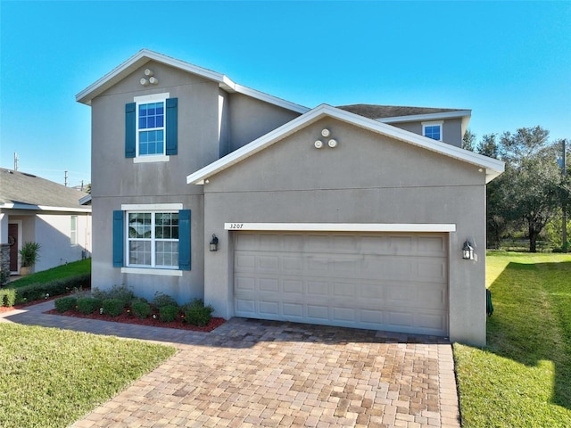 view of front of home with a front yard and a garage