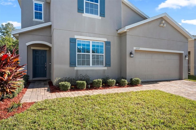 view of front facade featuring a front yard and a garage