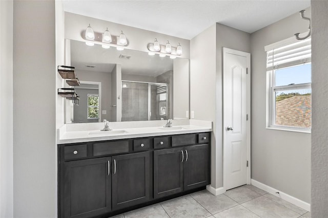 bathroom featuring vanity, tile patterned floors, and walk in shower