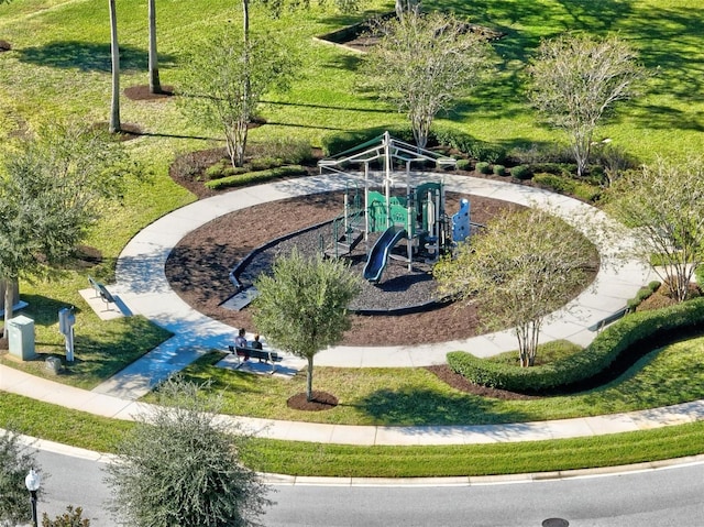 view of home's community featuring a playground and a yard