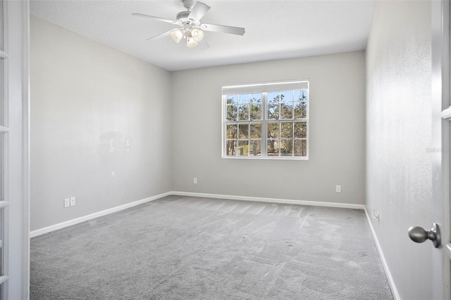 empty room with ceiling fan and carpet flooring