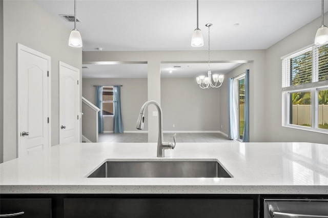 kitchen with hanging light fixtures, a notable chandelier, and sink