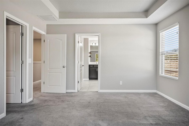 carpeted spare room featuring plenty of natural light