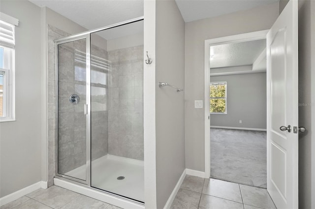 bathroom featuring tile patterned floors, walk in shower, and a textured ceiling