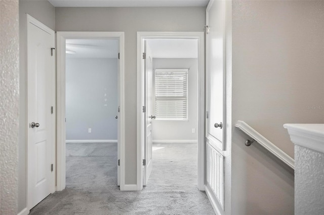 hallway featuring light carpet