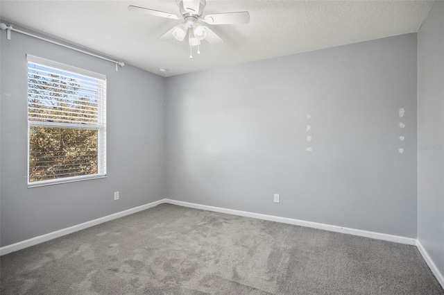 carpeted empty room featuring a textured ceiling and ceiling fan