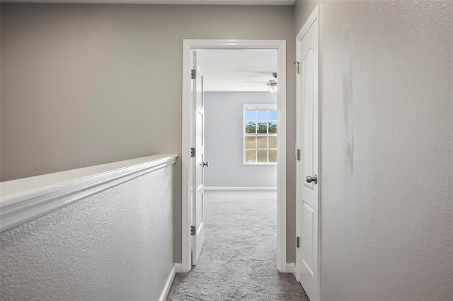 hallway with light colored carpet