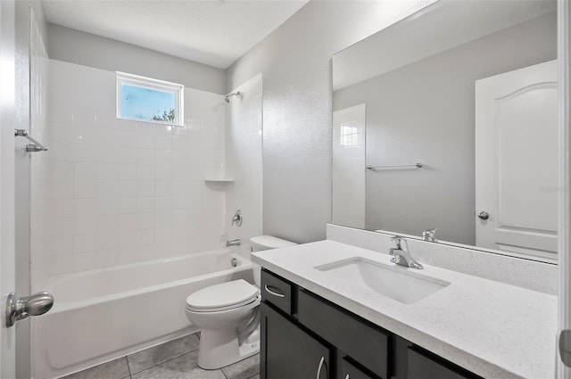 full bathroom with vanity, tiled shower / bath combo, toilet, and tile patterned flooring