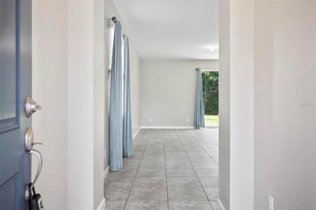 hallway with light tile patterned floors