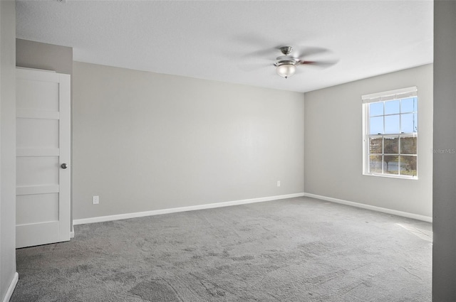 spare room with carpet flooring and ceiling fan