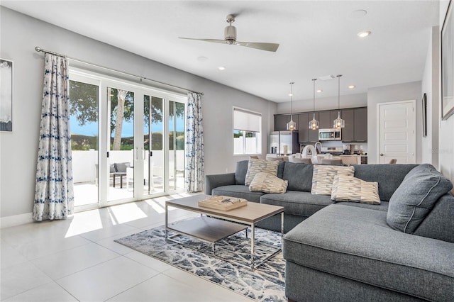 tiled living room with ceiling fan