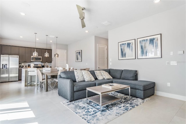 tiled living room with ceiling fan