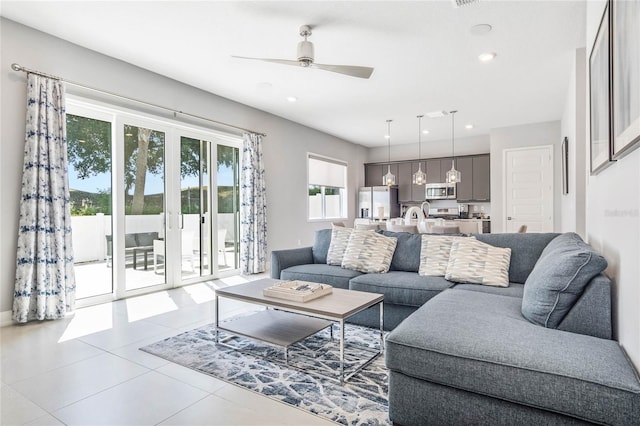 living room featuring ceiling fan and light tile patterned flooring