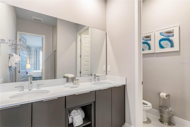 bathroom featuring toilet and vanity