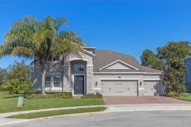 view of front of property with a garage and a front lawn