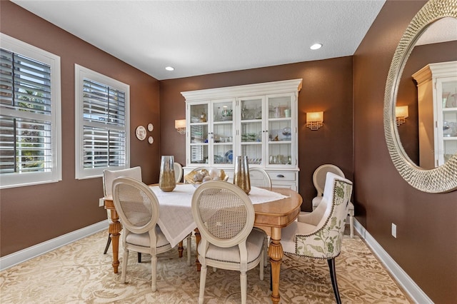 dining space with a textured ceiling