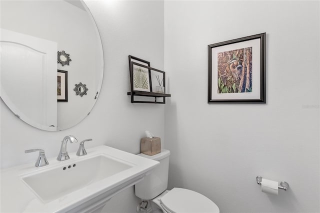 bathroom with toilet and sink