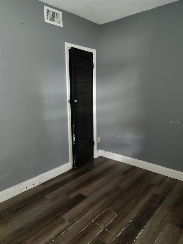 unfurnished room featuring dark hardwood / wood-style flooring