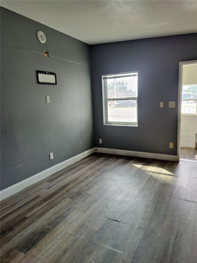 empty room with hardwood / wood-style flooring