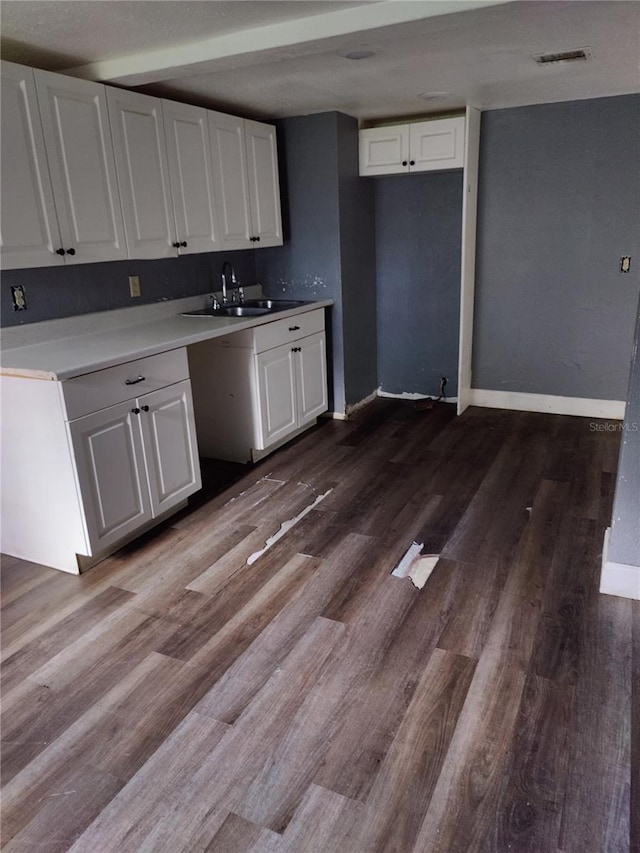 kitchen featuring white cabinets, wood-type flooring, and sink