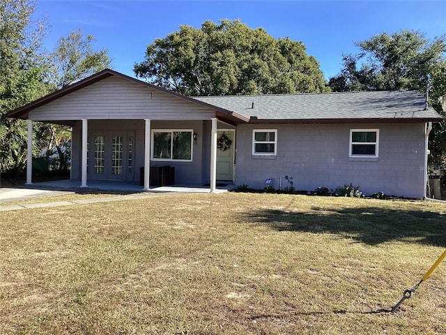 single story home with a front yard, roof with shingles, covered porch, french doors, and concrete block siding