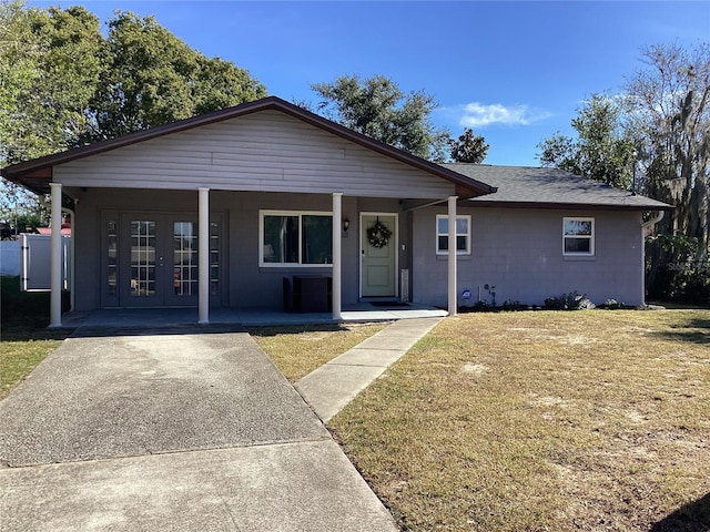 view of front of house with a front lawn, a porch, and french doors