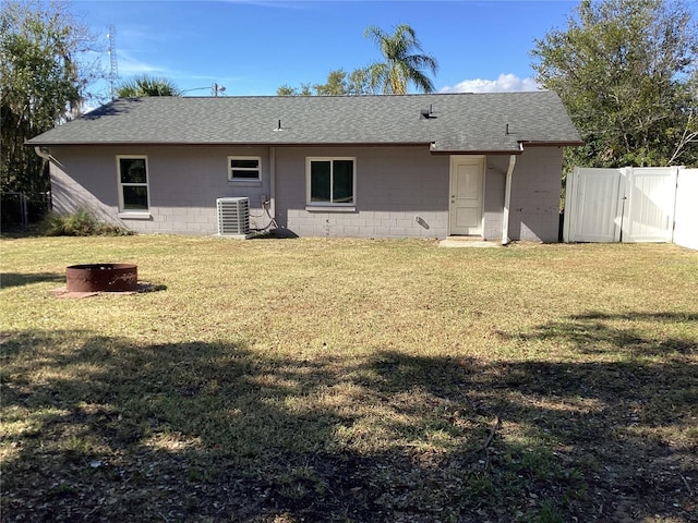 back of property featuring a lawn and cooling unit