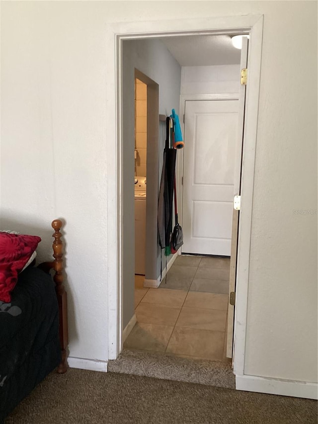 hallway featuring tile patterned floors and washer / clothes dryer