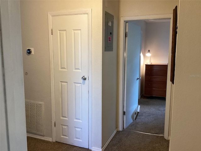 corridor with dark colored carpet and electric panel