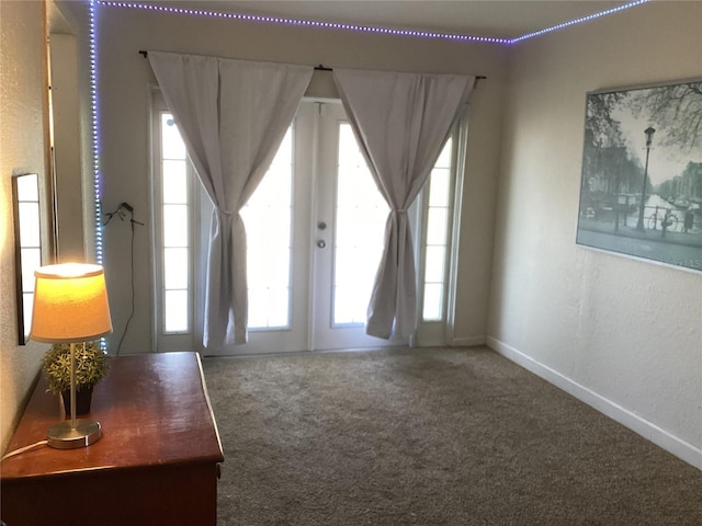 interior space featuring french doors and carpet