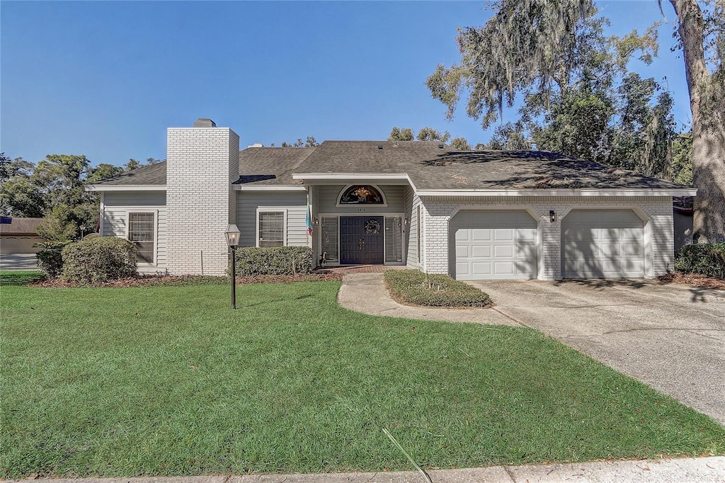 view of front of property featuring a front lawn and a garage