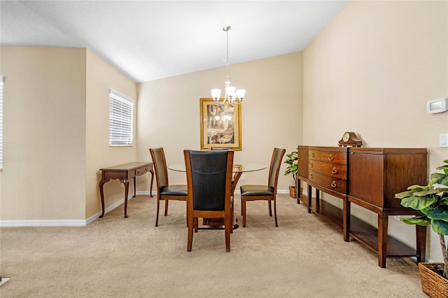 carpeted dining area with lofted ceiling and a chandelier