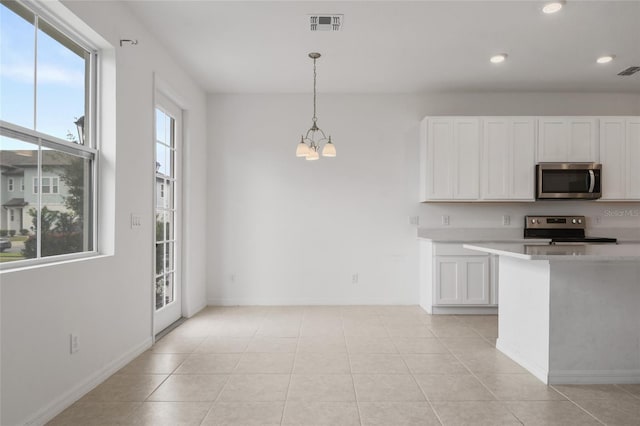 kitchen featuring stainless steel appliances, light tile patterned floors, a notable chandelier, white cabinetry, and hanging light fixtures