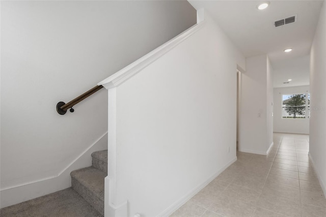 stairway with tile patterned flooring